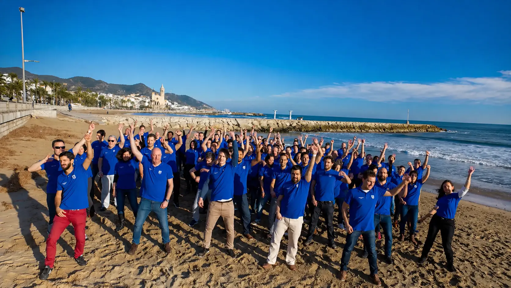 A company group taking part in a lipdub on the beach