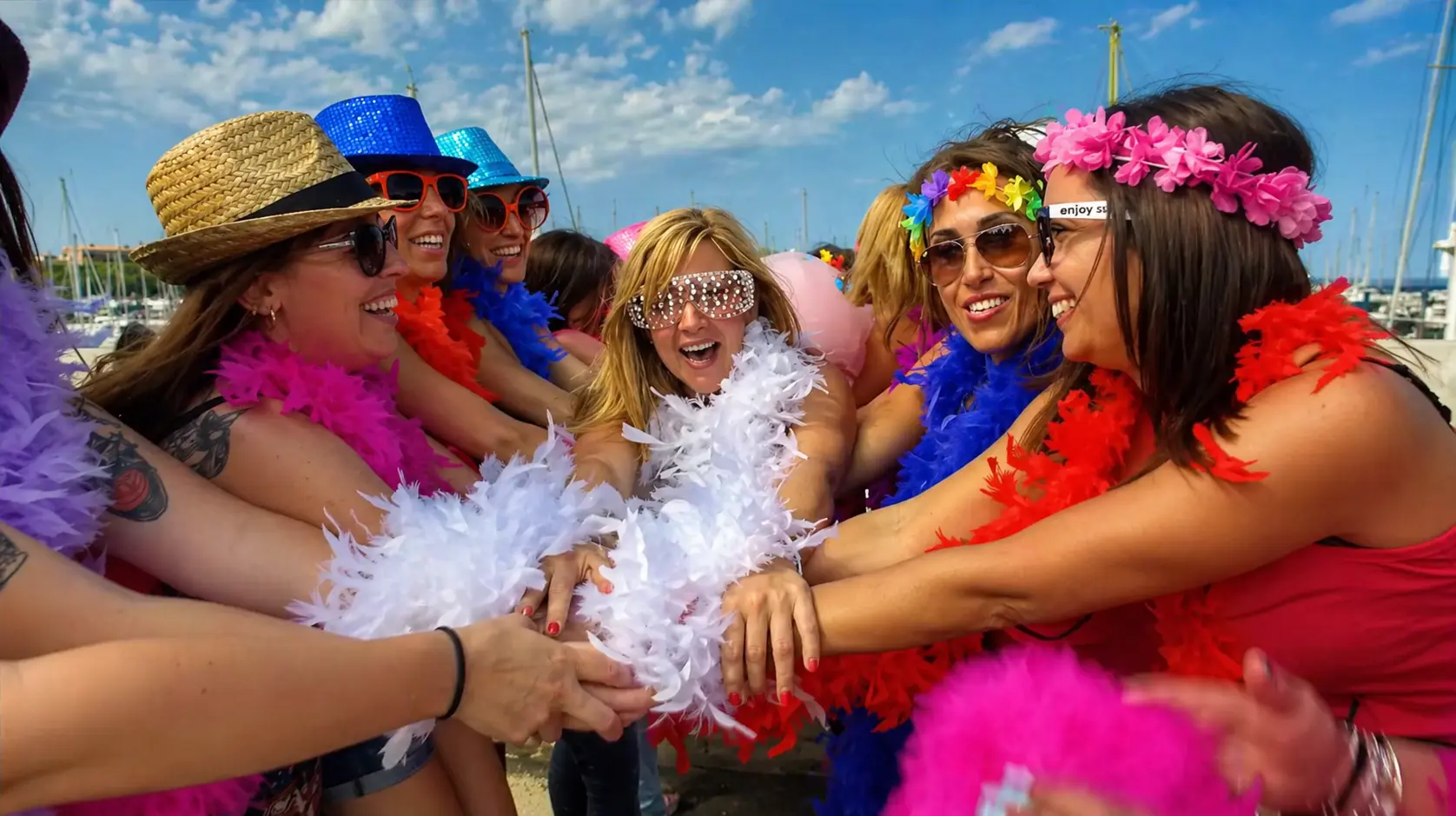 Friends celebrating a hen party while filming a lip dub beside Barcelona harbour